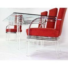 a glass dining table with red chairs around it