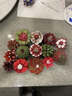 pine cones and flowers are sitting on the counter