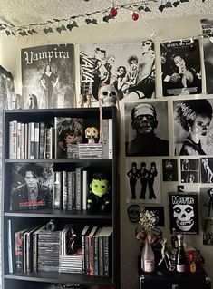 a book shelf filled with lots of books next to a wall covered in halloween pictures