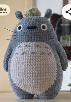 a crocheted totoro stuffed animal sitting on top of a table