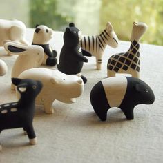 small wooden toy animals sitting on top of a table