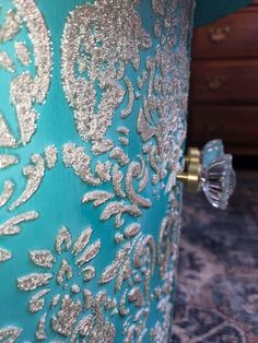 a close up view of the inside of a blue and silver vase with gold designs on it