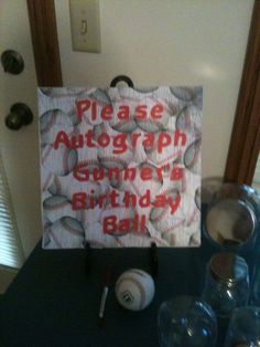 there is a sign that says please autograph someone's birthday ball on the table