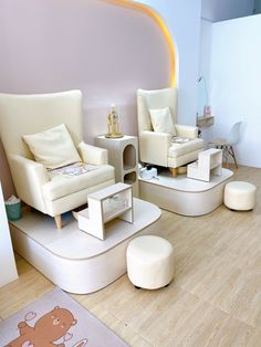 a living room filled with white furniture on top of hard wood flooring next to a pink wall