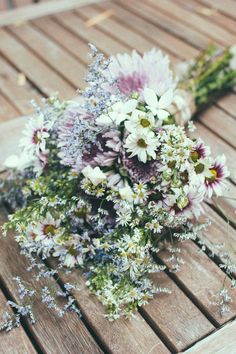 a bouquet of flowers sitting on top of a wooden table