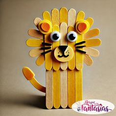 a popsicle lion made out of wood sticks with eyes on it's face