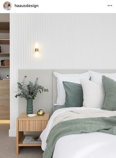 a bedroom with white walls and green pillows