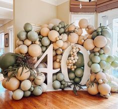 a large number made out of balloons in the middle of a room with wood flooring