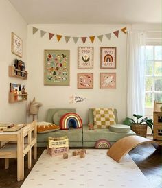 a child's playroom with toys and artwork on the wall, including a couch