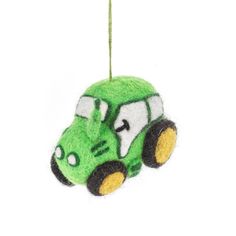 a green car ornament hanging from a string