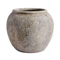 a large gray vase sitting on top of a white surface