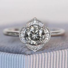 a diamond ring sitting on top of a cushion