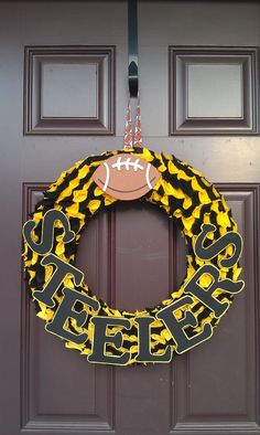 a football wreath is hanging on the front door