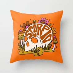 an orange pillow with the words crap on it and a skull in the center surrounded by flowers