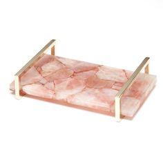 a pink marble tray with gold handles