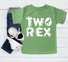 two rex t - shirt and pair of jeans on white wood background with sneakers