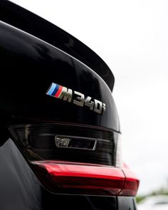 the rear end of a bmw car with its emblem on it's tail light