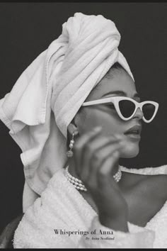 a woman with sunglasses and a towel on her head