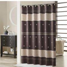 a bathroom with a shower curtain and rug