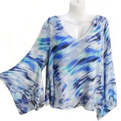 Flowy Layered Top In Blue Hues Sexy Bell Sleeve New With Tags Blue Flowy V-neck Top, Blue V-neck Top For Night Out, Trendy Light Blue V-neck Blouse, Trendy Blue Flowy Blouse, Blue Summer Blouse For Night Out, Trendy Light Blue Blouse For Vacation, Blue Blouse For Summer Night Out, Trendy Blue Blouse For Beach, Blue Stretch Blouse For Night Out