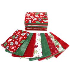 six red and green christmas napkins sitting on top of each other