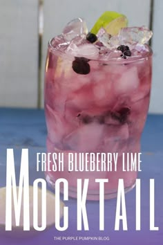 a drink with ice and berries in it on a table next to the words fresh blueberry lime mocko cocktail