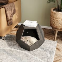 a white cat laying in an octagonal shaped pet bed