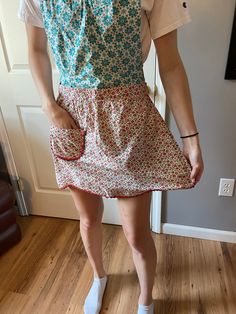 a woman standing in front of a door with her hands on her hips and wearing white socks