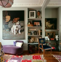 a living room filled with furniture and pictures on the wall above it's bookshelves