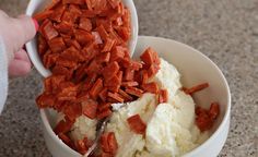 a person scooping up some food out of a bowl