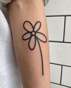 a woman's arm with a tattoo on it that has a black bow on it