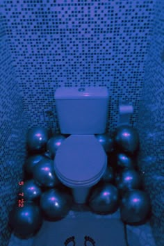 a bathroom with balls and a toilet in it