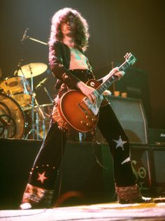 an image of a man playing guitar on stage