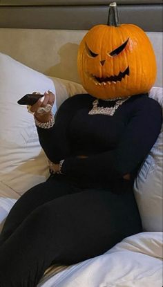 a woman sitting on top of a bed holding a remote