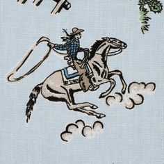 an embroidered picture of a cowboy riding a horse