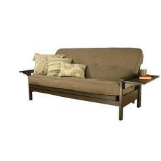 a futon sofa with pillows on it and a tray for the end table to sit on