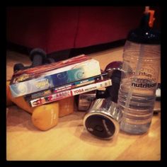 various items are sitting on the floor next to a water bottle