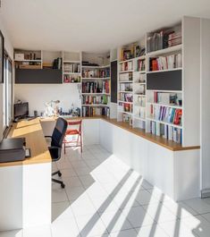 a home office with bookshelves and desk