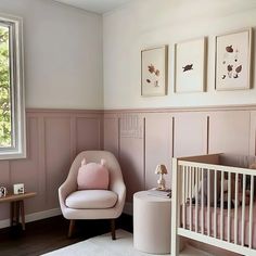 a baby's room with pink and white decor, including a crib and rocking chair