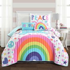 a bed room with a rainbow comforter and pillows