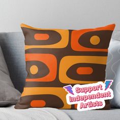 an orange and brown pillow with the words support independent artists on it