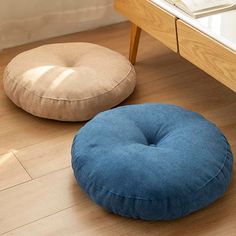 two round pillows sitting on the floor next to each other