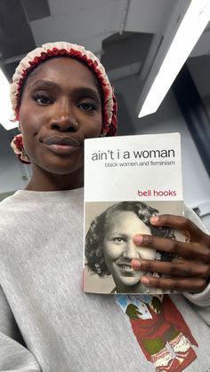 a woman holding up a book in front of her face