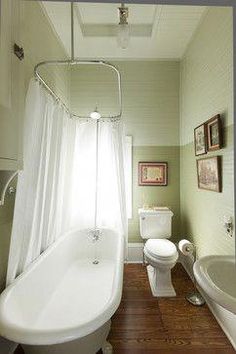 a white bath tub sitting next to a toilet in a bathroom