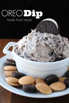 an oreo dip in a bowl with cookies on the side