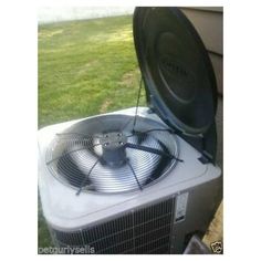 an air conditioner sitting outside in the grass