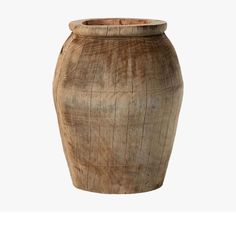 a large wooden vase sitting on top of a white background