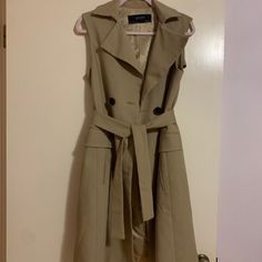 Zara Basic Collection Sleeveless Trench Coat Taupe/ Nude / Tan With Black Buttons Perfect Fall Staple! Size: X Small Like New Condition, Only Worn Once! Sleeveless Beige Outerwear For Work, Khaki Sleeveless Outerwear For Spring, Sleeveless Khaki Outerwear For Spring, Fitted Sleeveless Outerwear For Spring, Elegant Sleeveless Spring Outerwear, Beige Sleeveless Outerwear For Work, Formal Beige Vest Outerwear, Zara Sleeveless Outerwear For Fall, Khaki Workwear Vest Outerwear