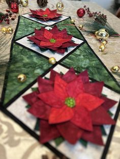 the table is decorated with poinsettis and pine cones