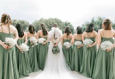 a bride and her bridal party in green dresses